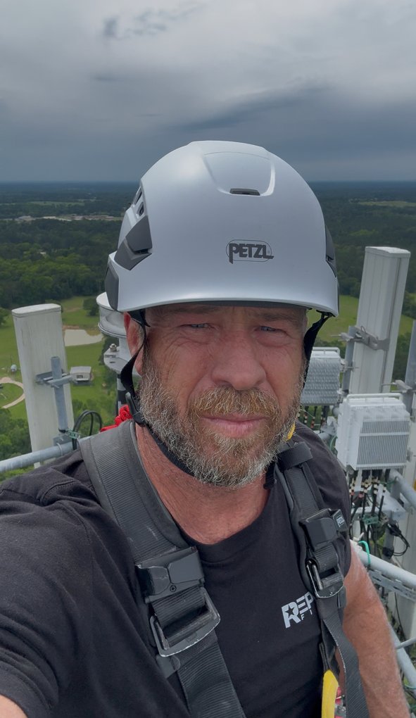 Destry Gruetzmacher working at the top of a tower