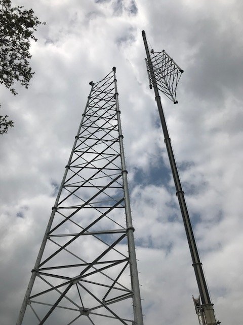 Guyed and self-support towers with a crane
